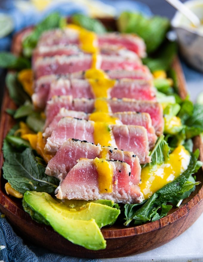 close up of the sliced tuna steak recipe with a drizzle of dressing 