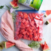 a large freezer bag filled with the watermelon and sealed is ready for the freezer