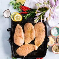 chicken breasts cooking over a grill griddle to make chicken chimichurri