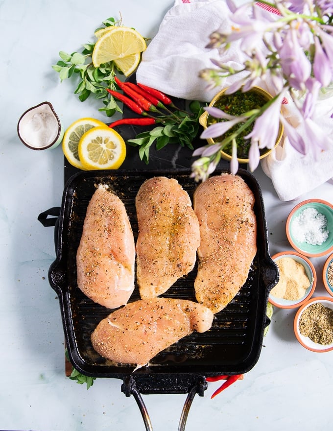 chicken breasts cooking over a grill griddle to make chicken chimichurri