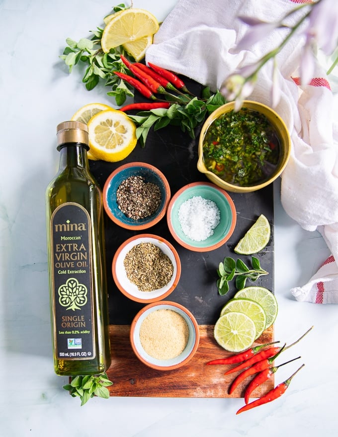 ingredients for chicken chimichurri including chimichurri recipe, spices to season the chicken and olive oil