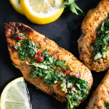 close up of one chicken drizzled with chimichurri recipe