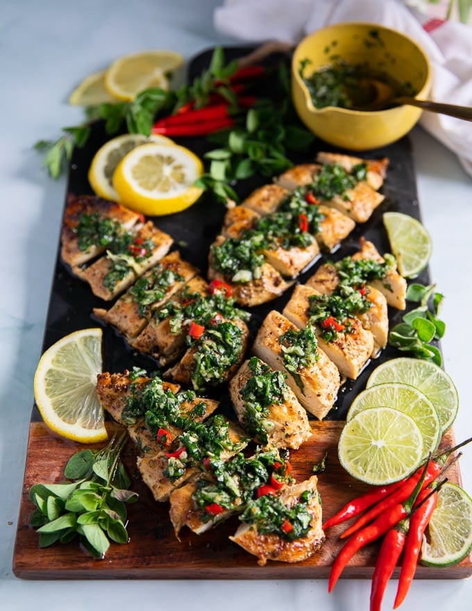 easy delicious chicken chimichurri served next to a bowl of chimichurri recipe