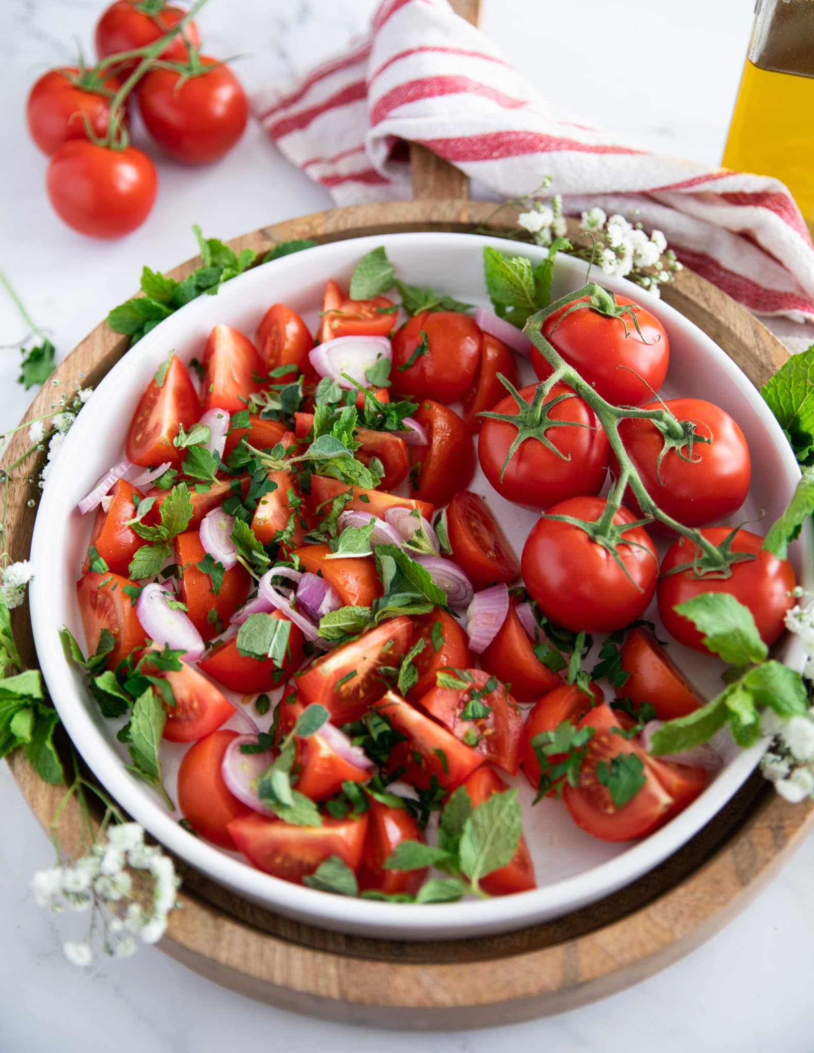 thinly sliced shallots and fresh herbs are added over the tomatoes