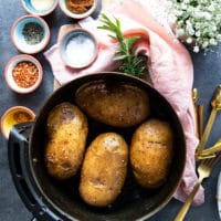 Seasoned Russet Potatoes in an air fryer basket ready to air fry