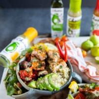 grilled salmon salad bowl all dressed up and loaded with avocado slices for a nutritious bowl