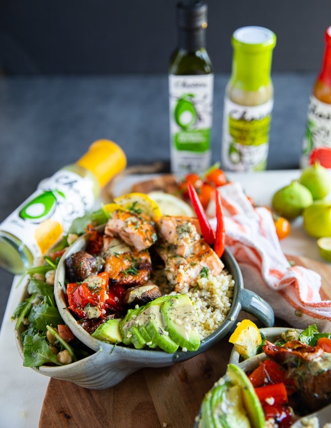 grilled salmon salad bowl all dressed up and loaded with avocado slices for a nutritious bowl