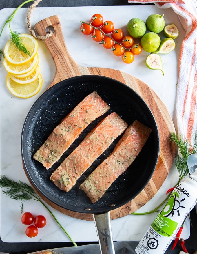 salmon fillets marinated and placed in a stove top grill pan