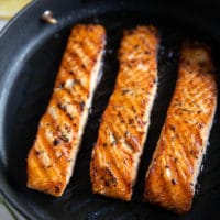 ready stove top grilled salmon in a stove top grill showing the texture and char on the salmon