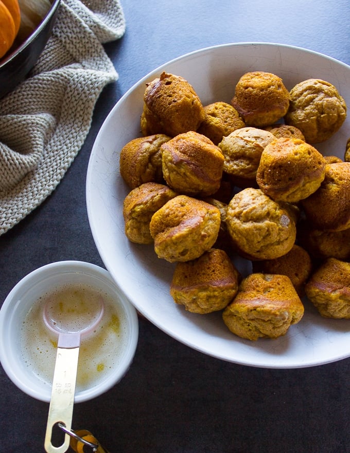 pumpkin donuts out of the oven and toassed in melted butter ready for the cinnamon sugar coating