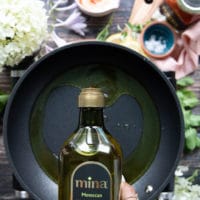 Olive oil being poured in a skillet for frying the halloumi cheese