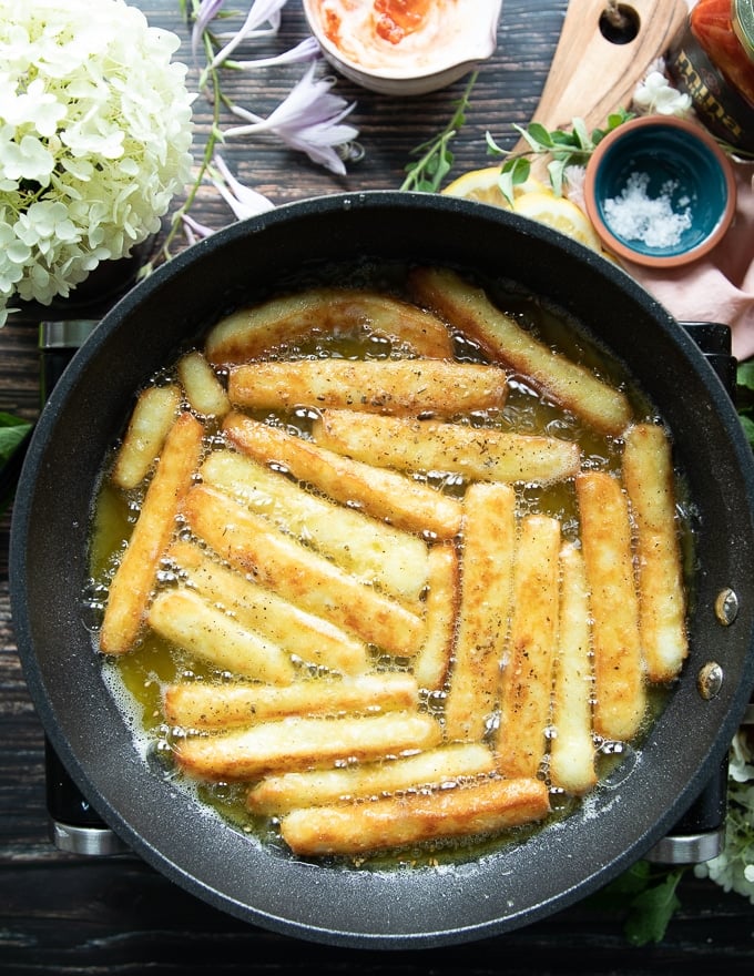 halloumi cheese frying and bubbling in a pan