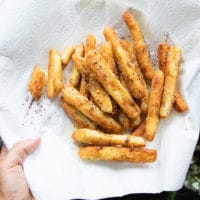 The halloumi cheese fries drying up on a paper lined plate to absorb excess oil