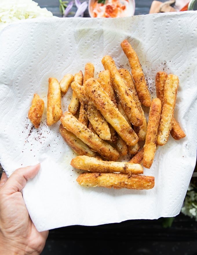 The halloumi cheese fries drying up on a paper lined plate to absorb excess oil