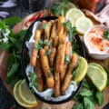 A basket of halloumi fries served with a squeeze of lemon juice and fresh mint