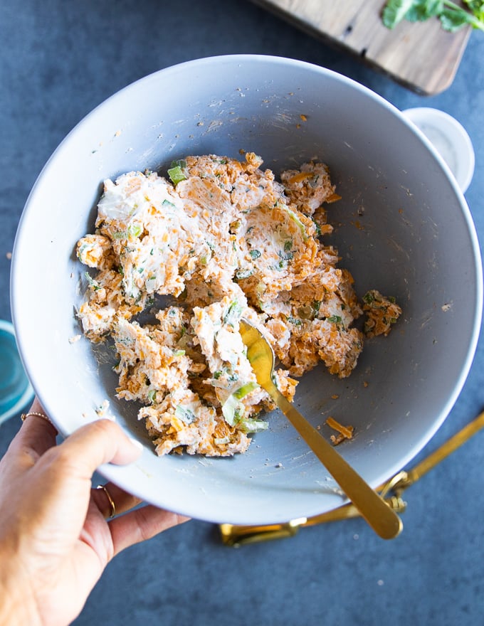 cream cheese filling mixed together in a bowl to stuff the jalapeno poppers