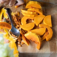 sliced honeynut squash on a cutting board