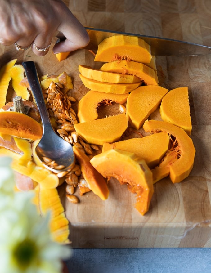 sliced honeynut squash on a cutting board