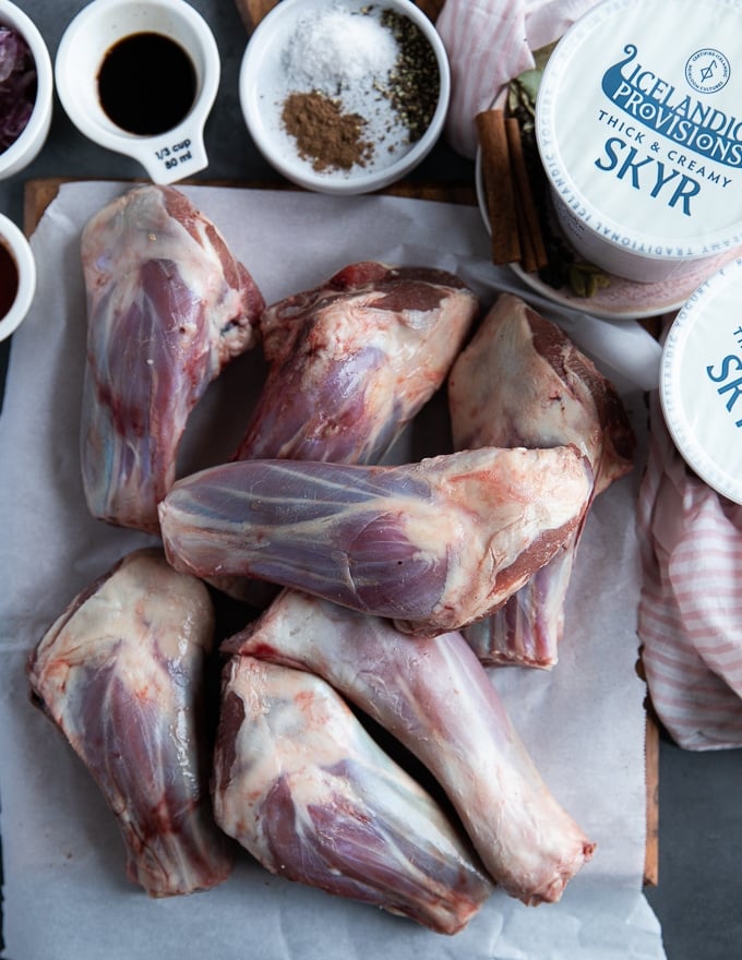 raw lamb shanks on a parchment paper on a plate, using american lamb