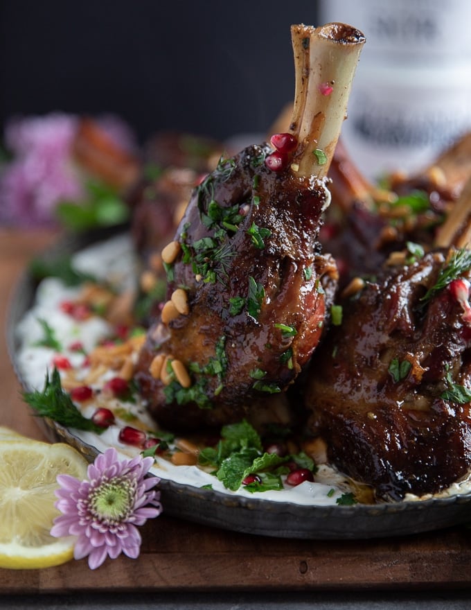 close up of a cooked lamb shank showing the golden color and juicy meat