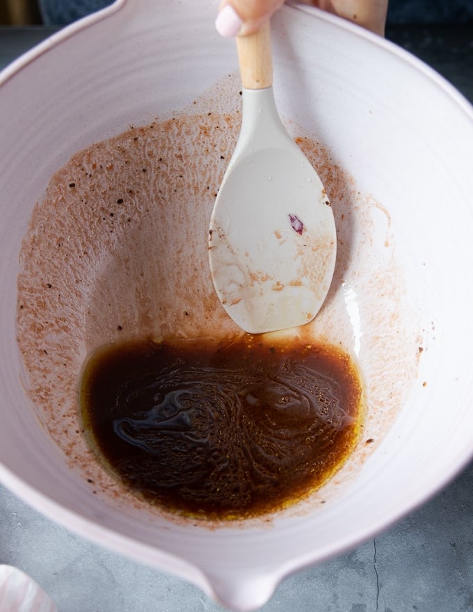 a bowl of a marinade mixed in for the lamb shanks including olive oil, soy sauce, balsamic vinegar, spices, ketchup