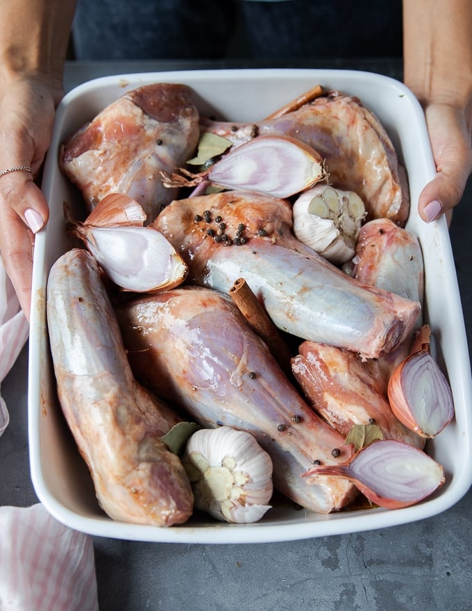 the marinated lamb shanks placed in an oven safe dish ready to roast