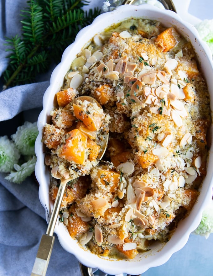 a serving spoon scooping out butternut squash casserole