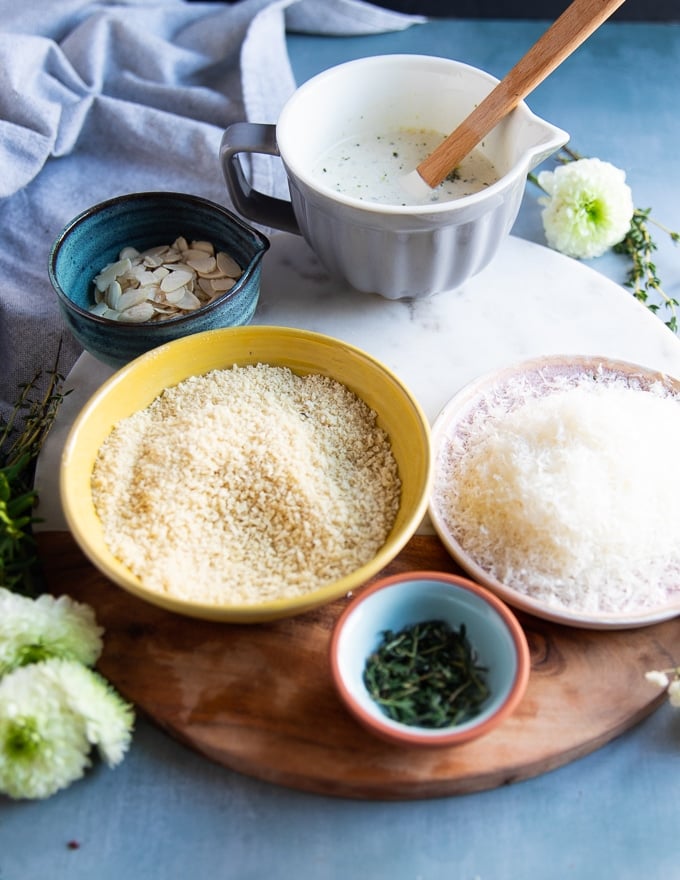 ingredients for the casserole topping including panko, Parmesan cheese, herbs, nuts and seasoning 