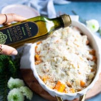 A final drizzle of olive oil over the casserole before it goes back into the oven