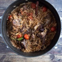 Fully cooked lamb shoulder chops and rice in the large pot ready to garnish and serve