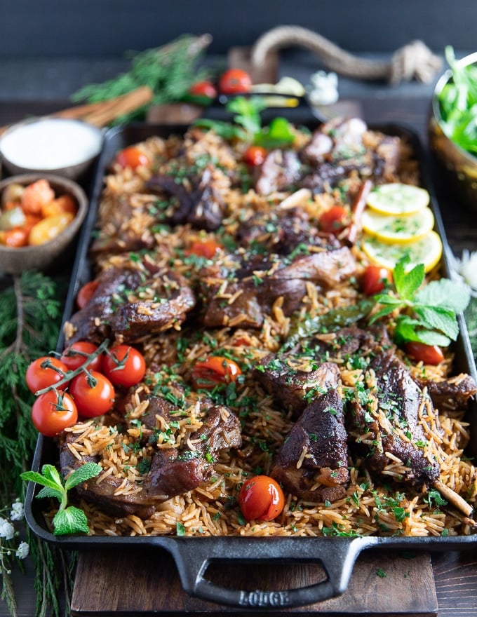 A plate of lamb shoulder chops cooked with rice and served for a one pot meal