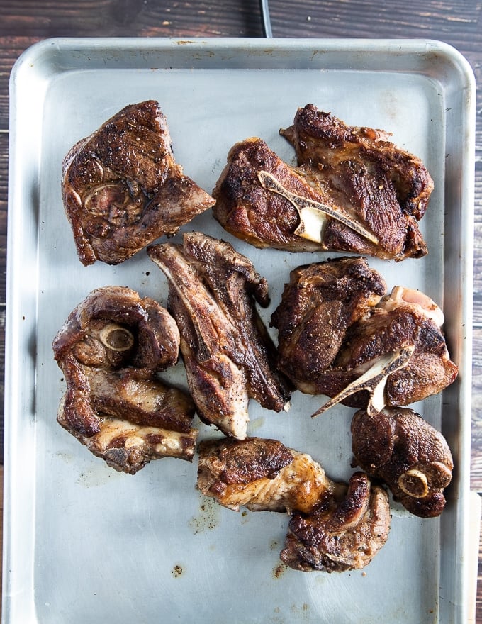 All the lamb shoulder chops seared and ready on a baking sheet