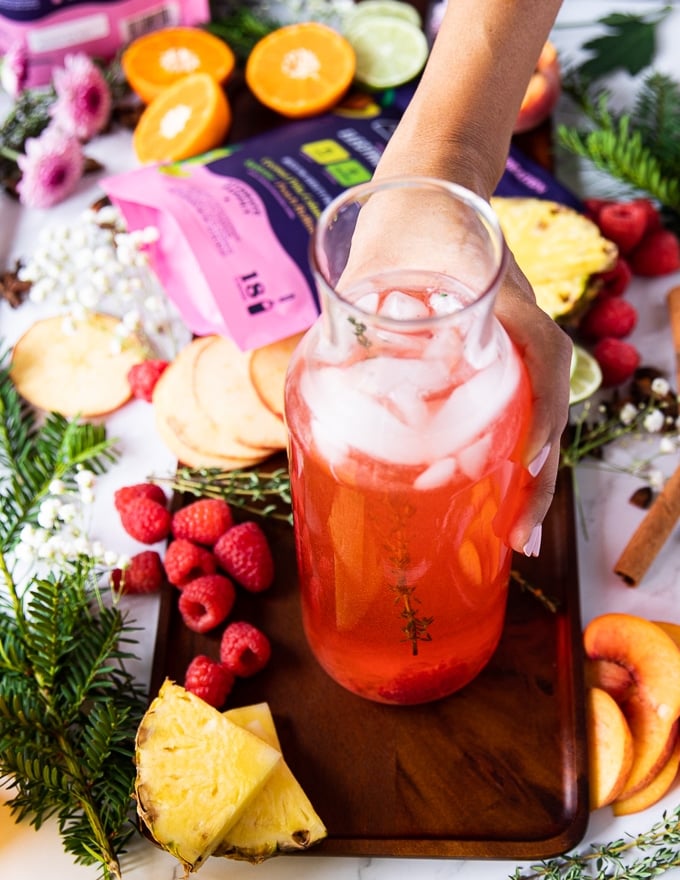 mixed up and ready peach bellini mocktail with fresh raspberries and fresh peaches ready to serve