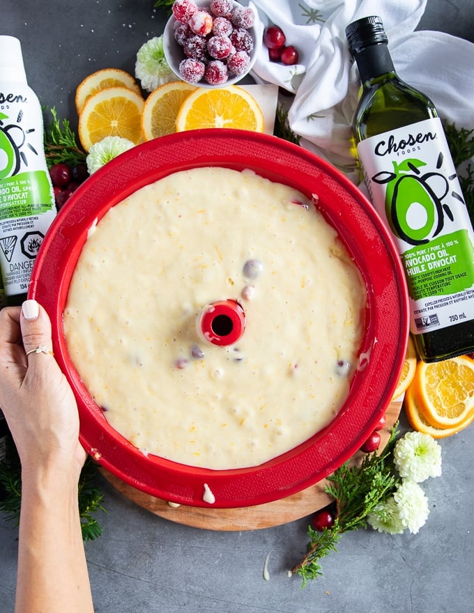 orange cake batter in a bundt cake pan ready to go in the oven