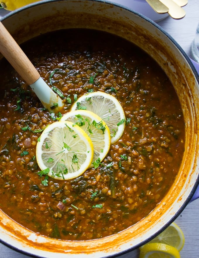 Lentil stew stirred in a dutch oven.