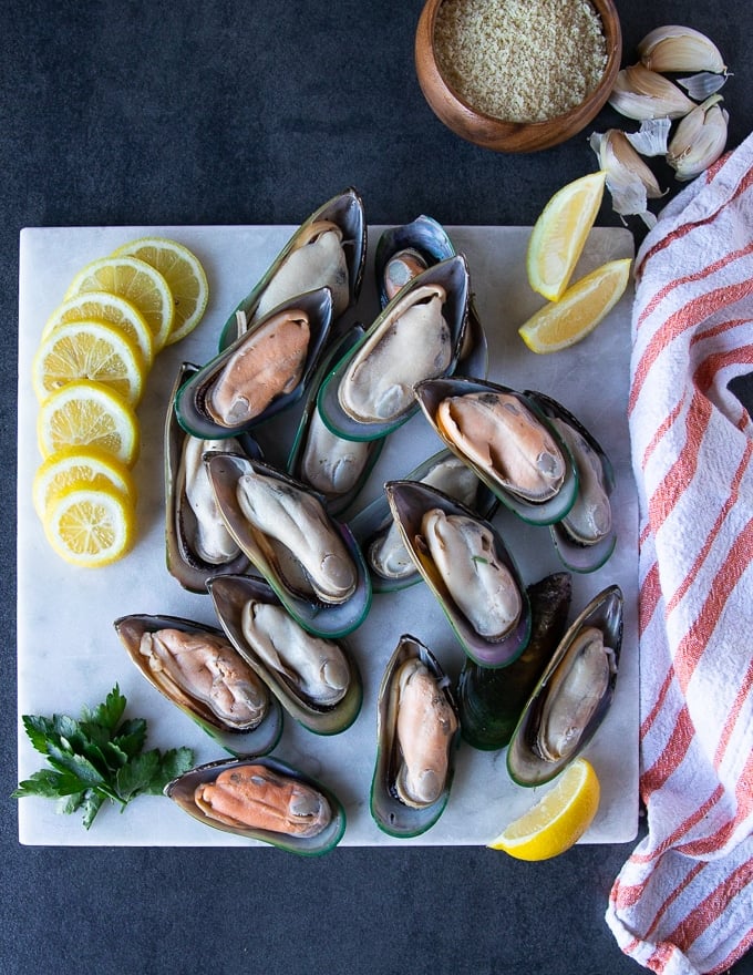 green mussels on a white marble