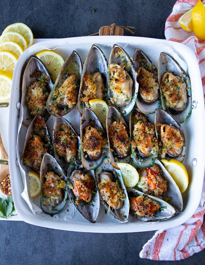 cooked green mussels on the baking tray out of the oven 