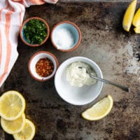 ingredients for the garlic sauce including garlic sauce, fresh herbs, lemon juice, seasoning