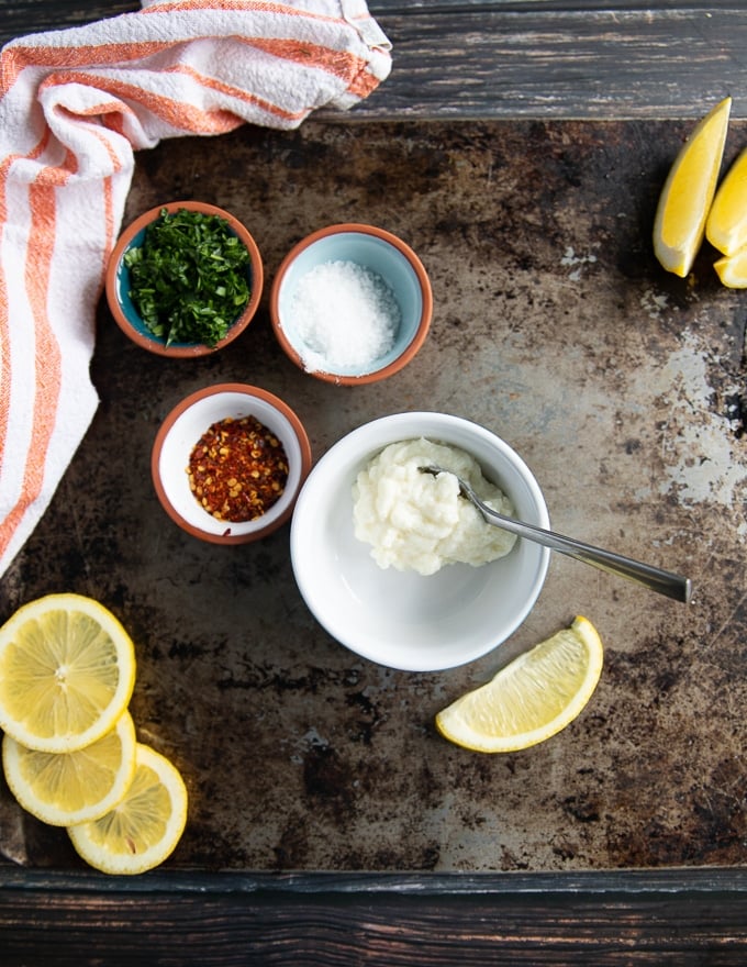 ingredients for the garlic sauce including garlic sauce, fresh herbs, lemon juice, seasoning 