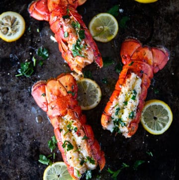 three lobster tails cooked perfectly on a baking sheet