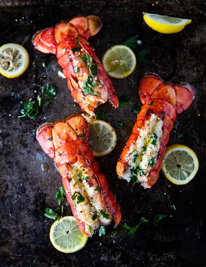 three lobster tails cooked perfectly on a baking sheet