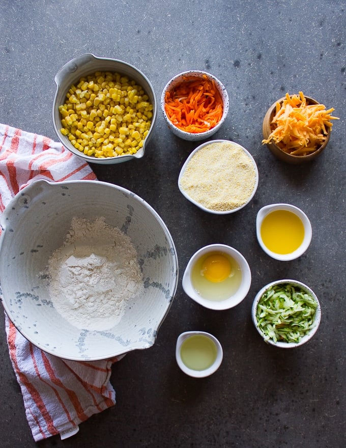 Ingredients for the cormbread recipe including flour, baking powder, cornmeal, grated cheese, eggs, fres corn, oil, grated carrots and zucchini 