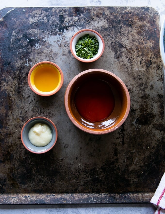 Ingredients for the sweet buffalo sauce including : hot sauce, garlic paste, honey and parsley