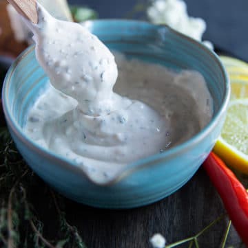 a bowl with a spatula holding up some blue cheese showing the thick twirl texture