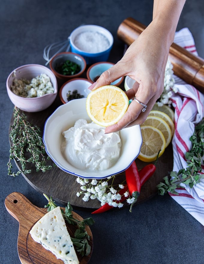 A hand holing a half lemon 