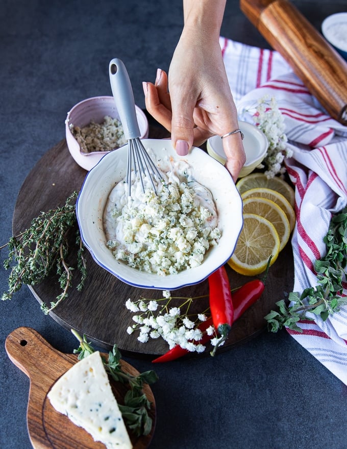 All ingredients of the homemade blue cheese dressing in a bowl