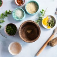 ingredients for the topping on baked scallops recipe including panko, garlic, lemon zest, fresh herbs and melted butter