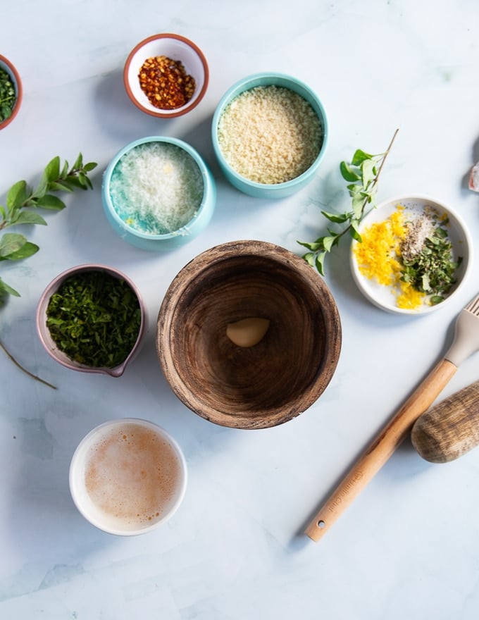 ingredients for the topping on baked scallops recipe including panko, garlic, lemon zest, fresh herbs and melted butter