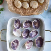A baking pan with scallop shells ready to bake scallops