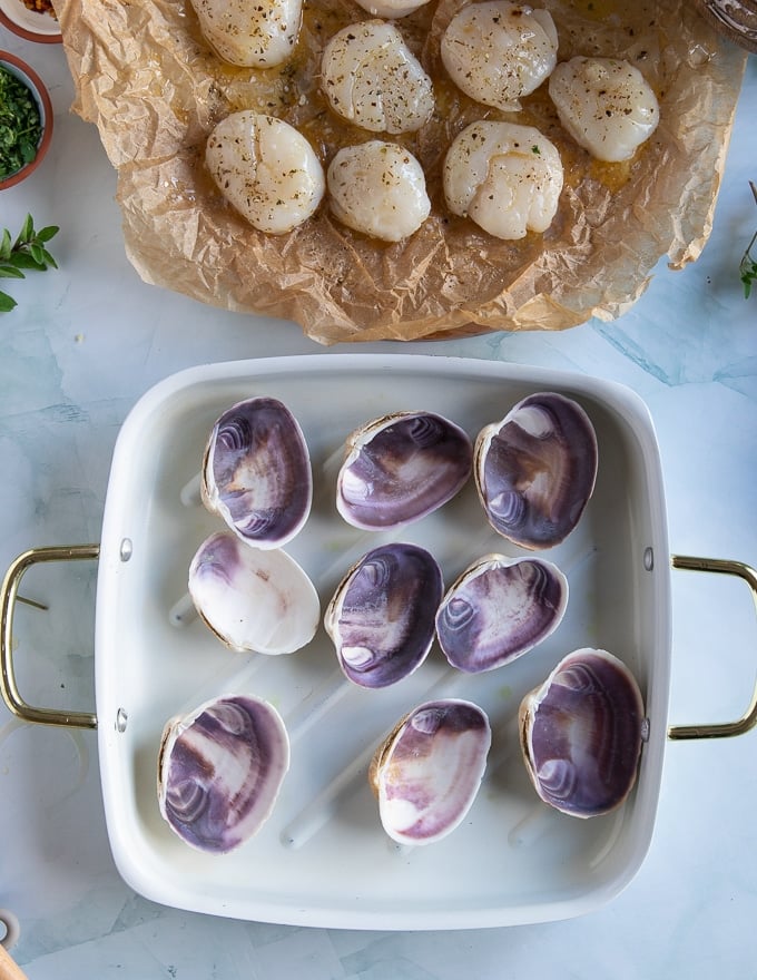 A baking pan with scallop shells ready to bake scallops